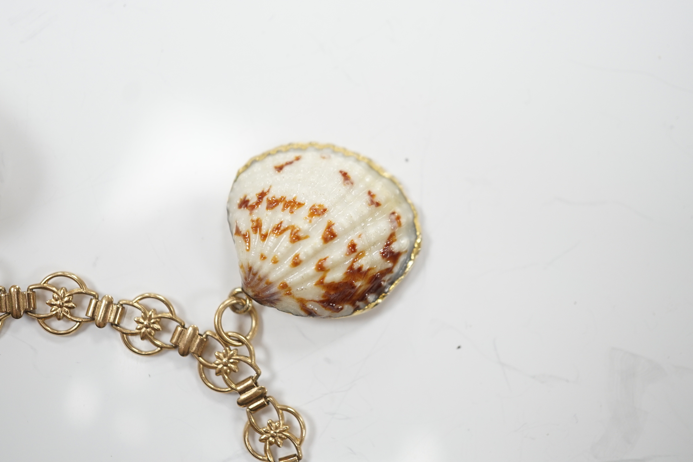 A modern 9ct gold charm bracelet hung with four shell charms, gross weight 19.1 grams.